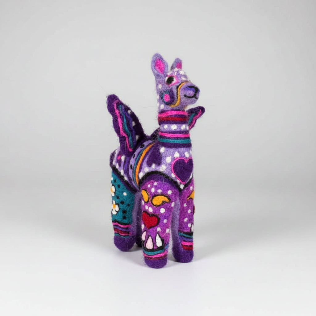 Colorful stuffed animal held by a hand against a plain background