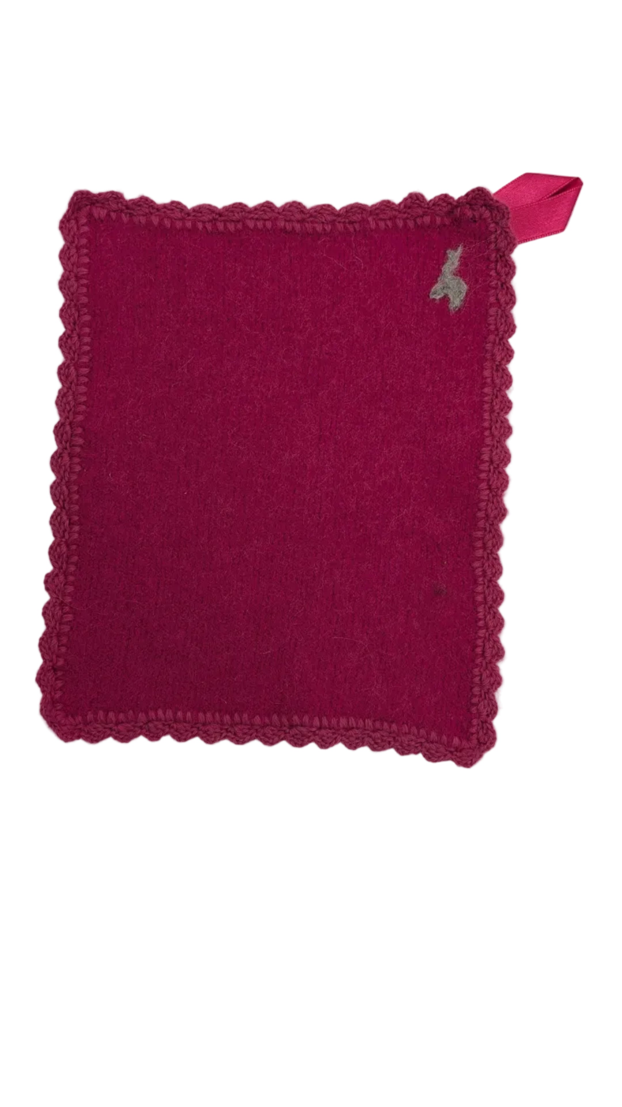 Pink knitted square with a small felted alpaca design and hand embroidered edging