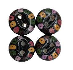 Four round buttons with floral patterns on a white background