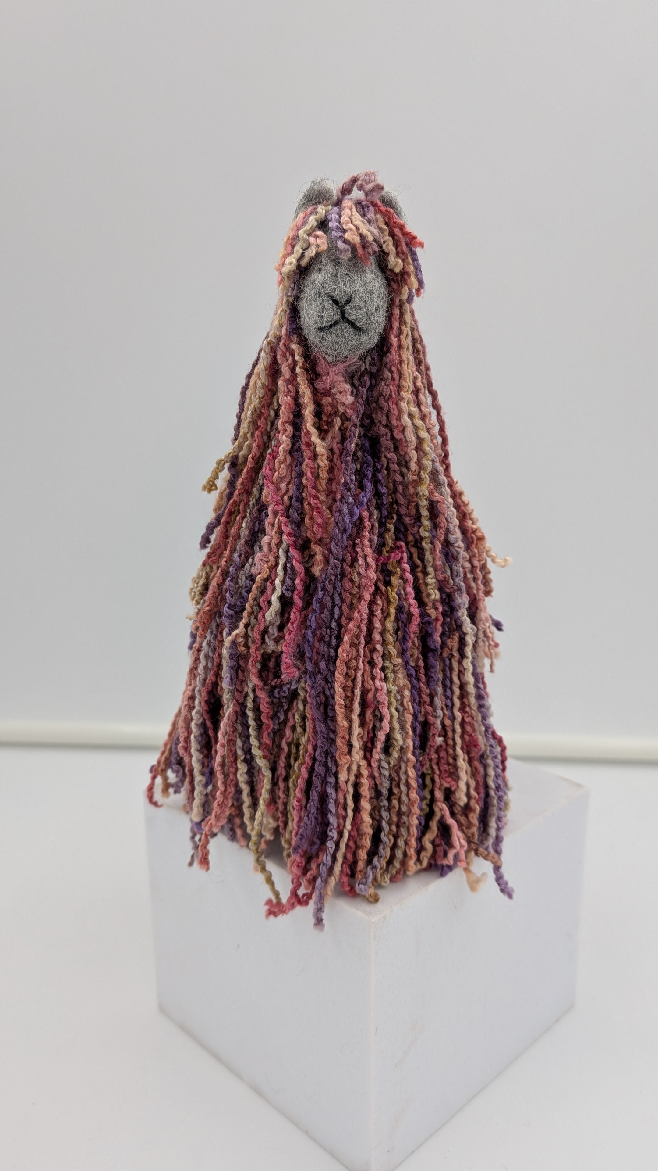 Textile art figure with long, braided hair handmade