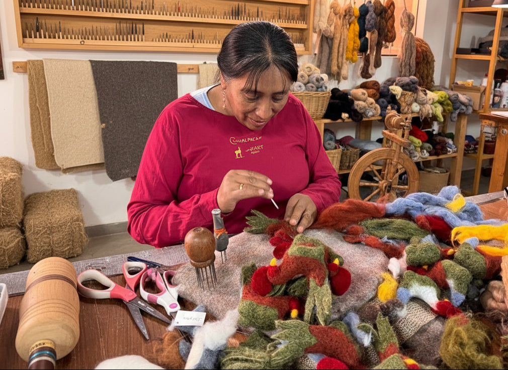 Martita working on colorful felted rooster in her studio