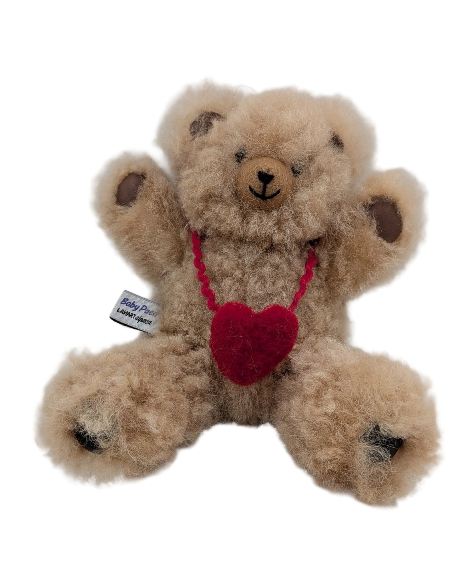 Teddy bear with a red heart and tag on a white background