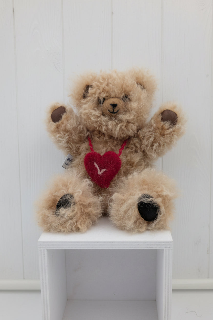 Teddy bear with a red heart in a white box on a light gray background