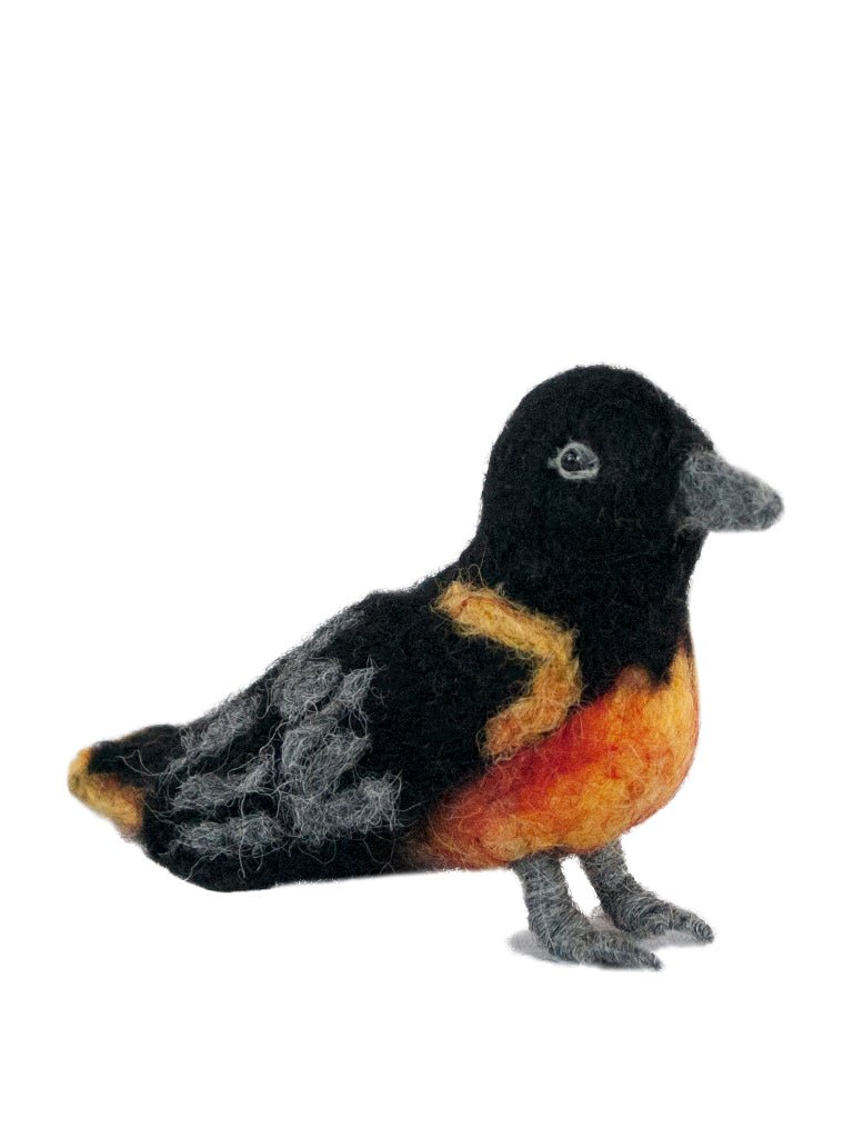 Handmade felted oriole bird sculpture in bright orange and black alpaca fiber.