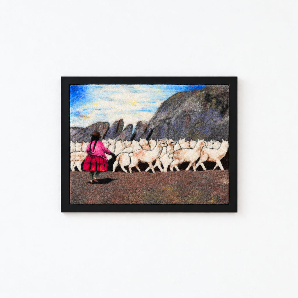 A Peruvian shepherd with her alpacas in the andes