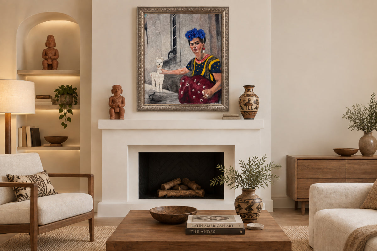 A framed portrait painting of Frida Kahlo with a white alpaca, displayed on a wooden floor against a white wall. The painting features Frida in her signature blue flower hair accessory, yellow and blue dress, and red skirt, reaching toward the white alpaca.