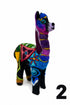 A colorful felt llama figurine decorated with vibrant geometric and floral patterns in purple, blue, green, yellow, pink, and black, set against a plain white background.