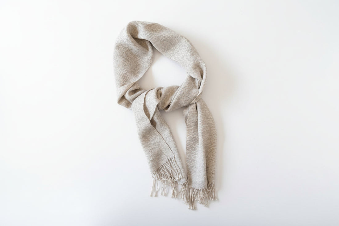 Beige and gray scarf with fringe on a white background