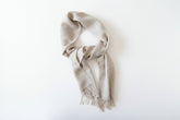 Beige and gray scarf with fringe on a white background