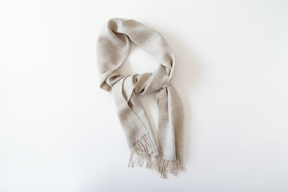 Beige and gray scarf with fringe on a white background