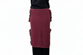 Maroon skirt with fringe details worn by a person against a plain background