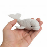 Small beluga white whale held in a hand against a white background handmade 