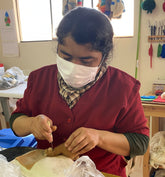 Artist felting a lanart alpaca cria huacaya in her studio at Lanart