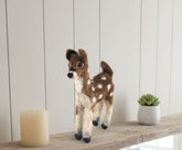 Deer figure with brown and white fiber on a shelf white background