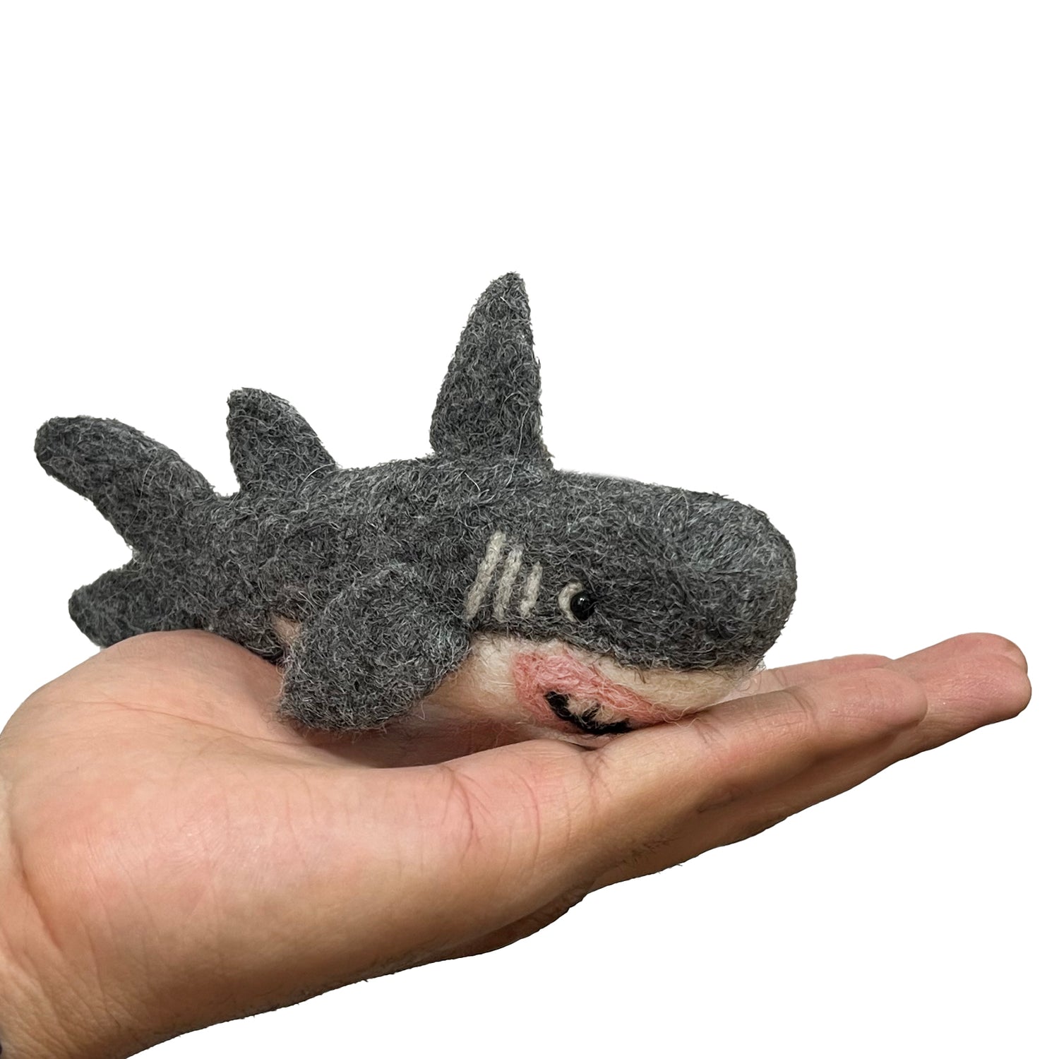 Small shark ornament held in a hand 