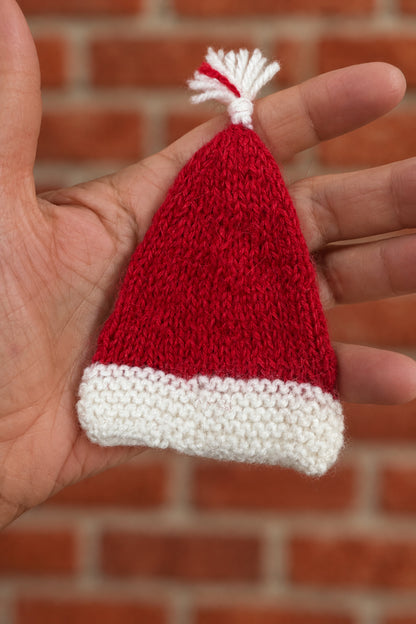 Hand knit alpaca yarn santa hat in hand