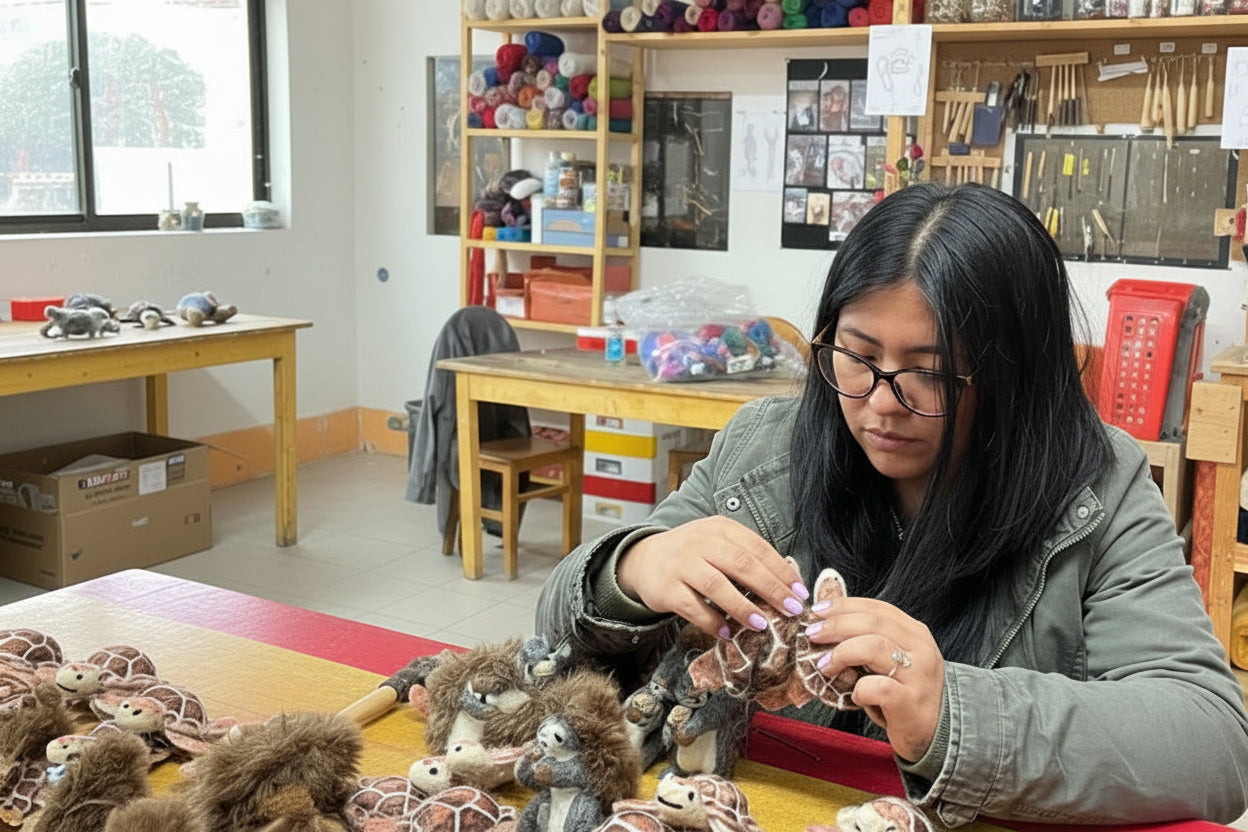 Person working on small hawksbill turtle items in an artist workshop setting