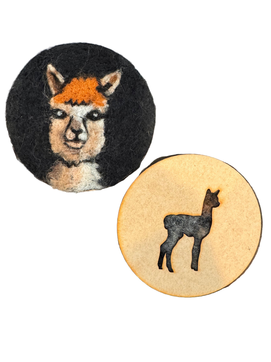 Two felted coasters with alpaca  cutout on a wooden surface