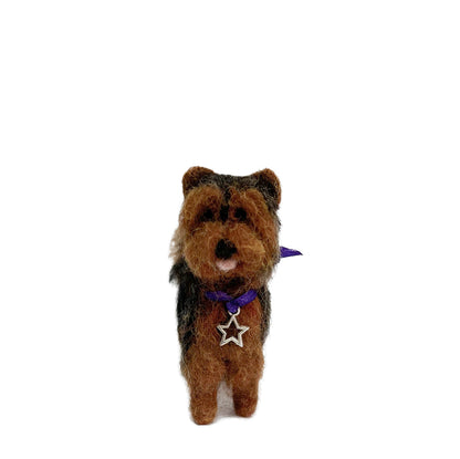 Stuffed needle felted ornament with a purple collar and star tag on a white background