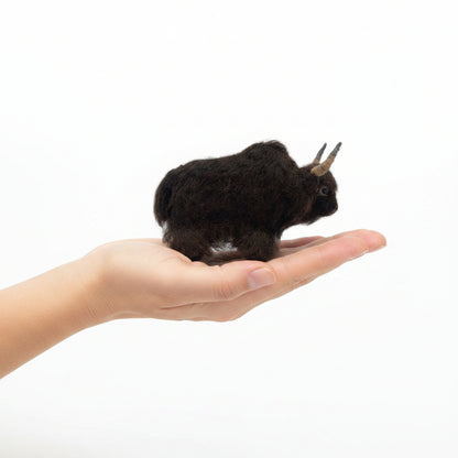 Plush yak of a dark brown alpaca fiber with horns on a white background