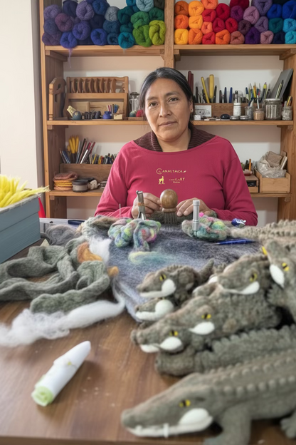 Person wearing a face mask sitting at a table with felted animal toys