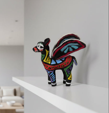Colorful decorative animal figure on a white shelf with a neutral background
