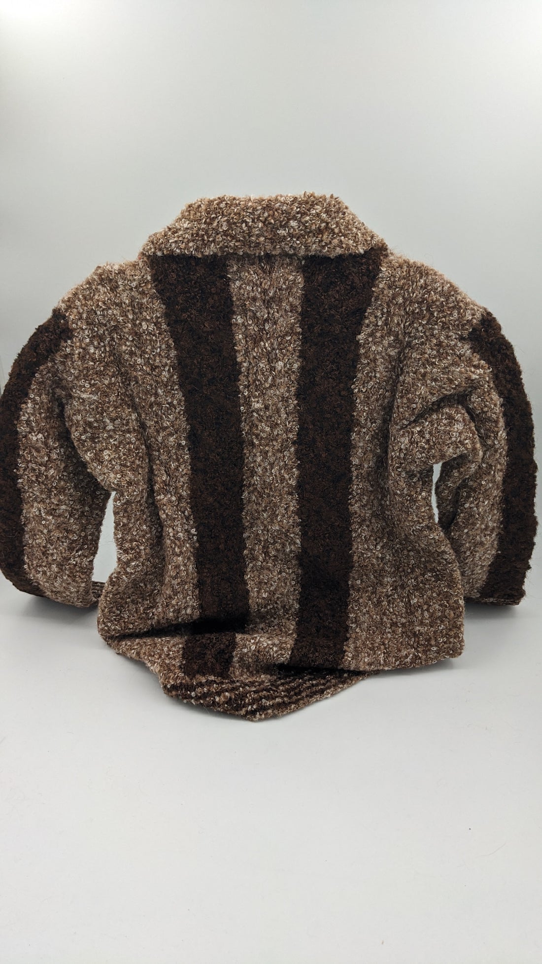 Kids brown and black striped cardigan sweater on a white background