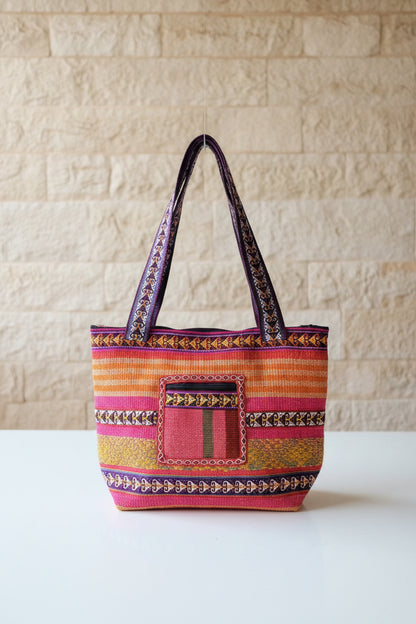 Colorful handbag with intricate patterns on a shelf in a store.