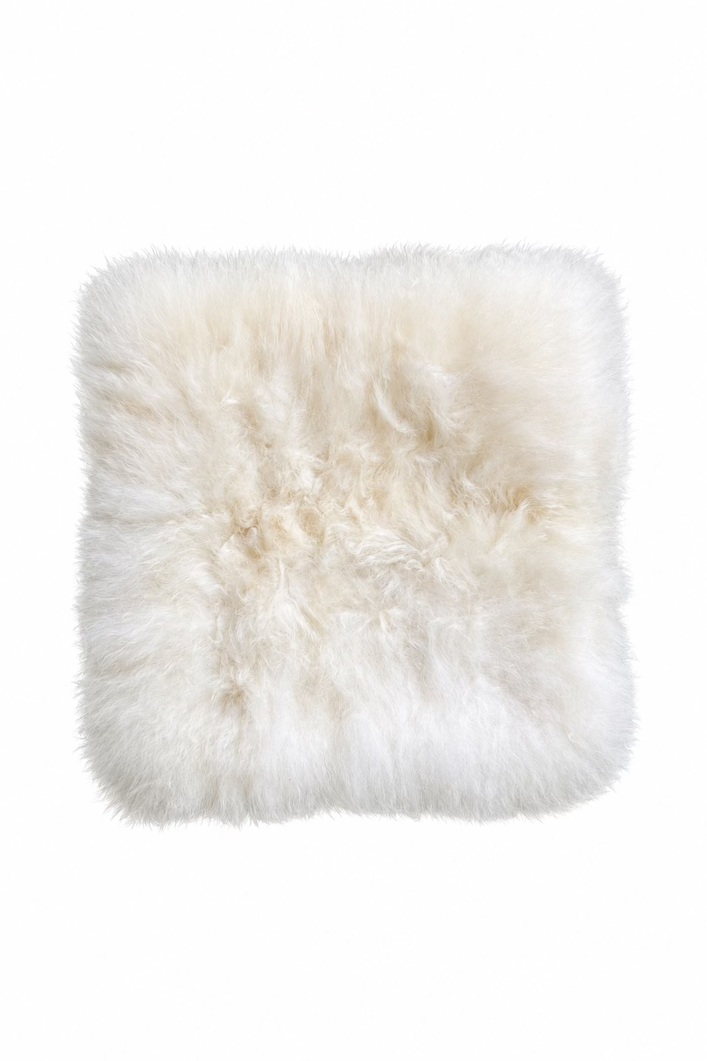 A square fluffy alpaca-fur pad in off-white/cream, laid flat.
