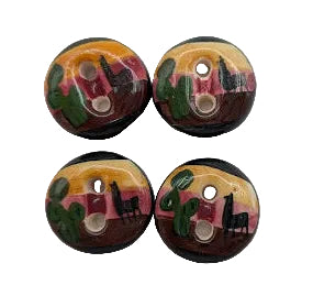 Four ceramic buttons with abstract face designs on a white background