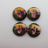Four ceramic buttons with abstract face designs on a white background