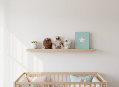Nursery room with wooden crib and shelf displaying decorative heirloom lanart alpaca 
teddy bears..