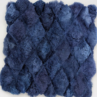 Blue textured rug with a diamond pattern on a white background