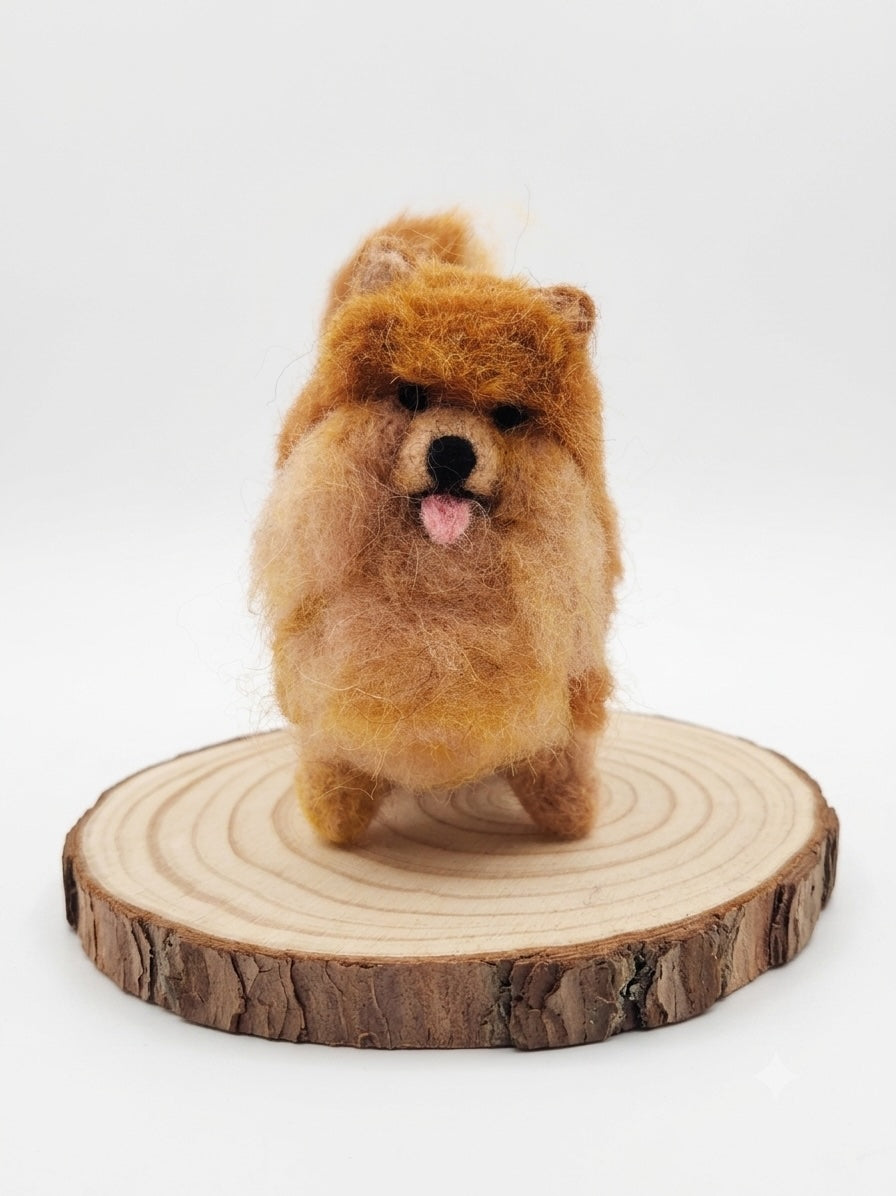Felted brown dog figurine on a wooden base with a white background