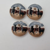 Four wooden buttons with black and gray designs on a white background