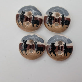 Four wooden buttons with black and gray designs on a white background