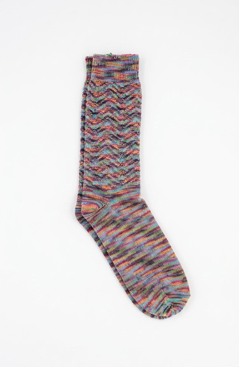 A single multicolor knit sock with a wavy chevron pattern, displayed flat against a plain white background.