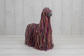 Knitted llama toy on a white background
