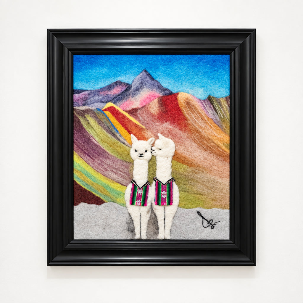 Framed artwork of two llamas in a colorful mountainous landscape
