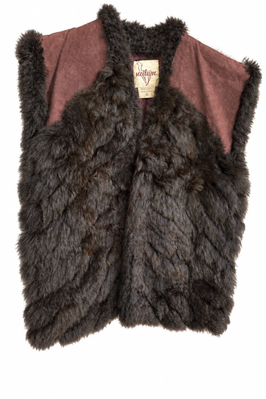 A sleeveless fur vest displayed. The vest features a dark brown shaggy fur body with dusty brown suede shoulder panels and a brown fur trim at the collar.