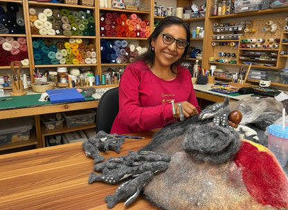 Woman working with yarn and craft materials in a workshop setting