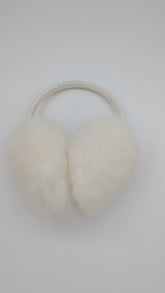 A pair of fluffy white faux-fur ear warmers attached to a thin beige elastic band, shown on a plain light gray background.