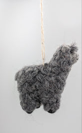 A small gray alpaca-shaped hanging ornament made from curly wool or felt, suspended by a thin string against a plain light background.