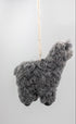 A small gray alpaca-shaped hanging ornament made from curly wool or felt, suspended by a thin string against a plain light background.