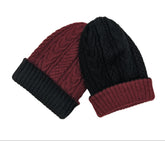 Two knit hats, one black and one red, on a light beige background