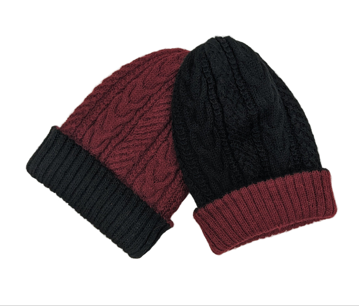 Two knit hats, one black and one red, on a light beige background