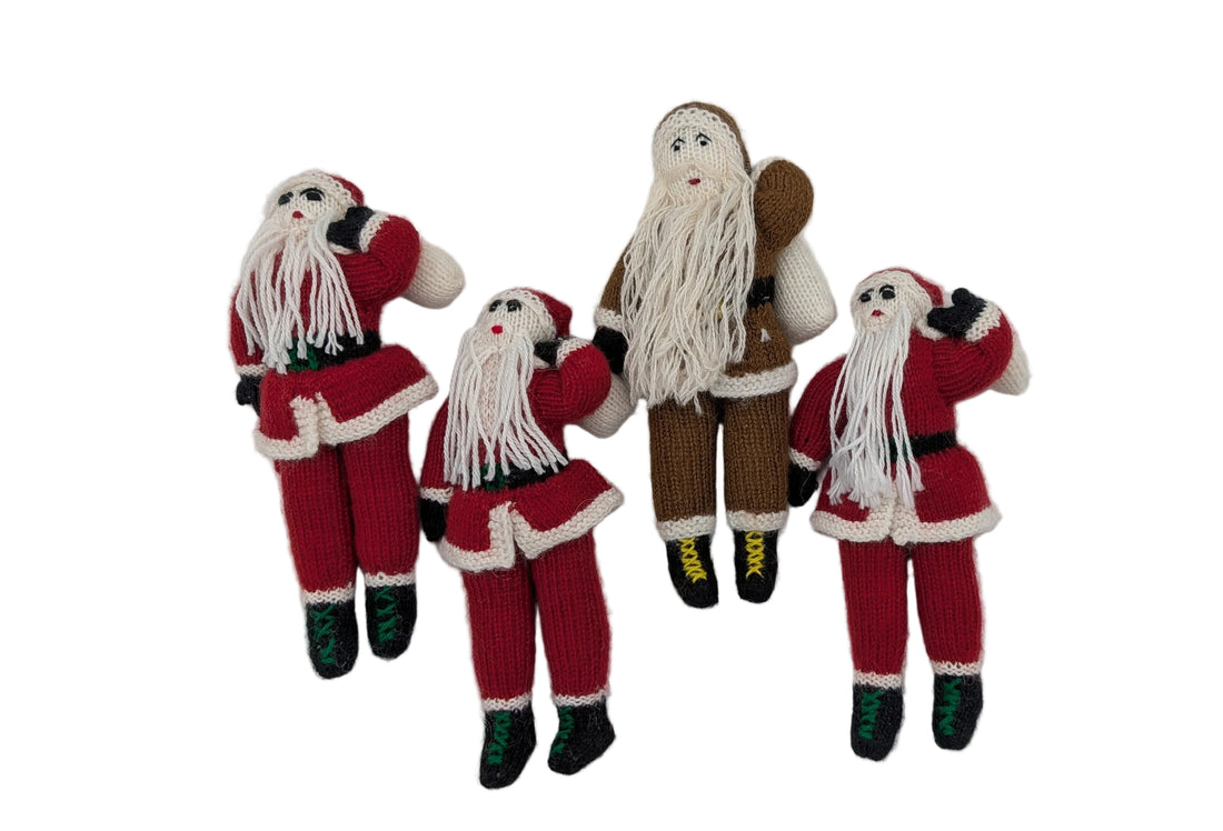 Four handmade knitted Christmas Santa Claus figures arranged vertically on a plain white background.