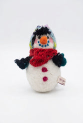 A needle-felted alpaca fiber snowman sculpture with a red hat, blue smile and carrot nose, against a white background.