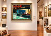 Framed artwork of a city street scene with people and dogs, featuring a prominent &