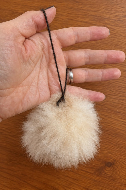 Felted alpaca fur pompom featuring a handcrafted face with 